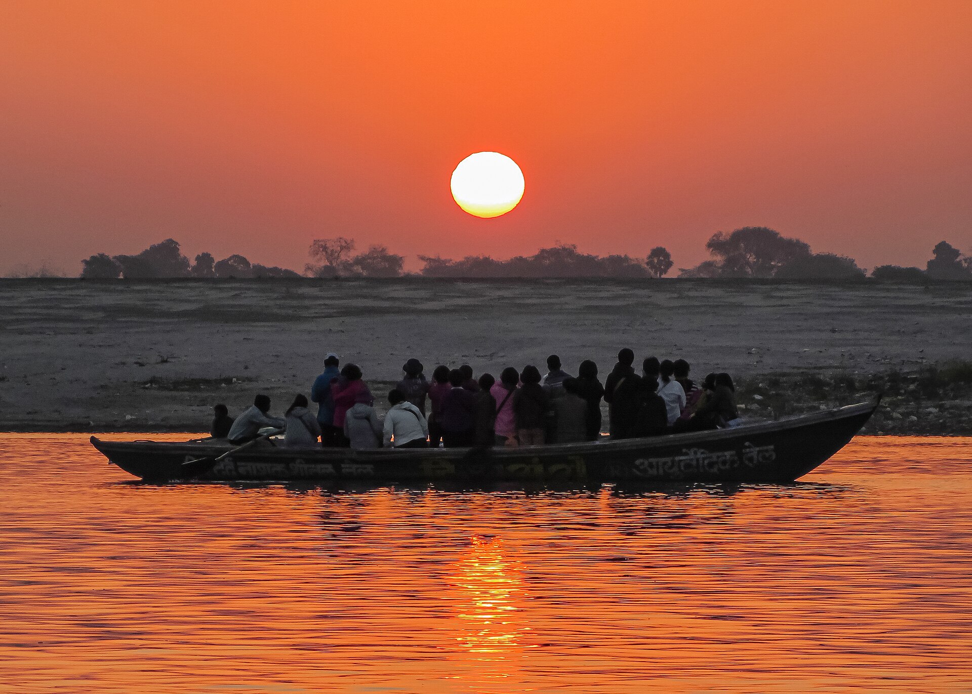 Boats crossing the Ganges at sunrise in Varanasi