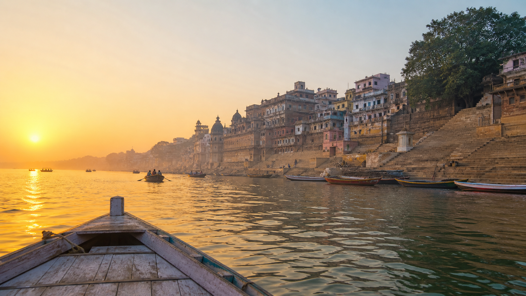 Sunrise boat view of the Ganges and historic ghats in Varanasi